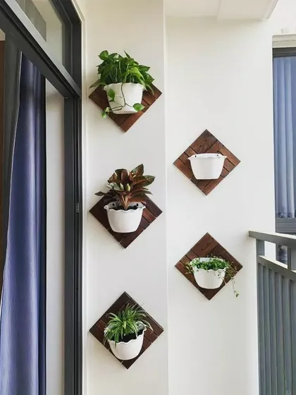 These diamond-shaped wooden mounts are a stylish way to display plants on a wall. They turn individual pots into a coordinated art installation, perfect for a balcony or any indoor wall that needs a touch of life.