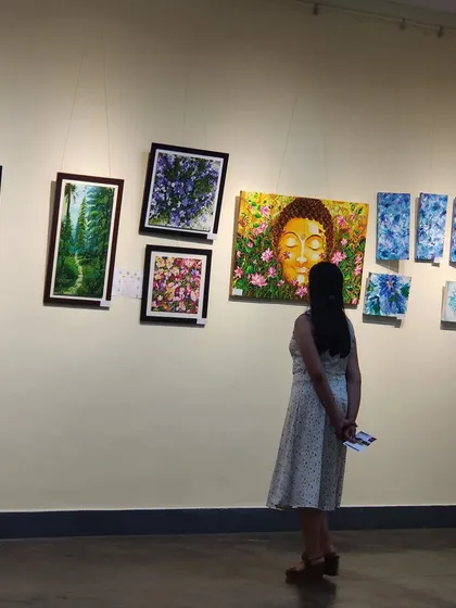 A quiet moment of a visitor appreciating the art at the gallery.