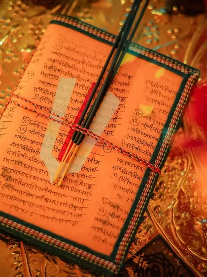 A detail of the personalized prayer books and incense sticks provided to guests at the Sunderkand event, showing my commitment to creating a holistic and thoughtful experience.