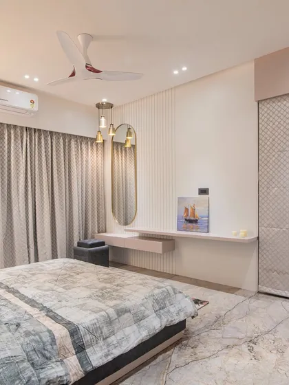 A look at the other side of the room, showing a floating dressing table with a modern oval mirror. The textured wardrobe doors add another layer of subtle detail to the design.