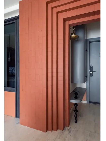 The stepped design of the entrance foyer's brick wall adds architectural interest and enhances the sense of grandeur as you walk in.