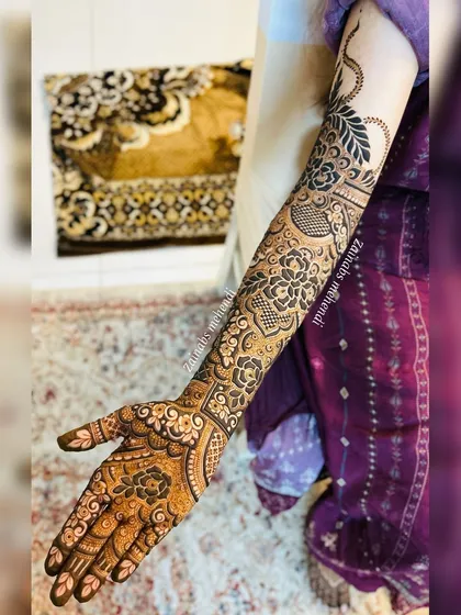 A full arm view showing how the Arabic vine elegantly wraps around the arm, connecting the different sections of the design.