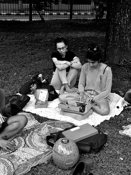 A black and white snapshot of a Saturday gathering. We start as strangers around a blanket, and through poetry, we leave as souls who have shared something timeless. These moments are what I live for.