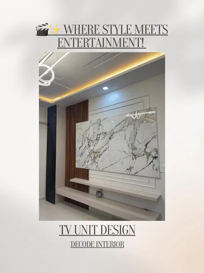 A TV unit should be more than just functional; it should be a centerpiece. This custom-designed unit combines a marble-finish panel with wooden fluting and floating shelves, creating a stylish focal point for the living room.