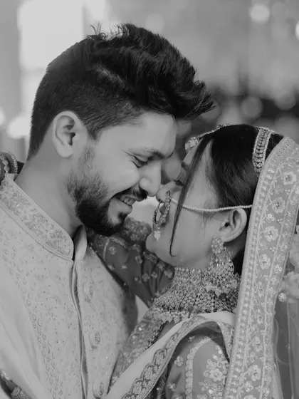A candid black and white shot capturing the pure, unadulterated joy between the couple. Their smiles are infectious, a perfect representation of their "Tom and Jerry" dynamic.