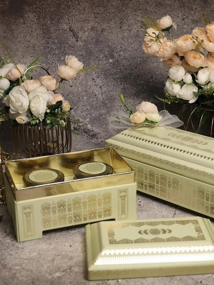 These elegant pastel green boxes with a haveli-inspired design are a sophisticated choice for Diwali gifting. They can be filled with sweets, dry fruits, or other small presents.