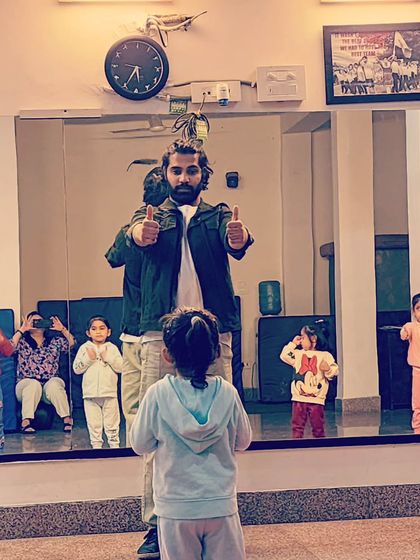 Giving a thumbs-up for a job well done. Positive reinforcement is key in my classes to build confidence in our young learners.