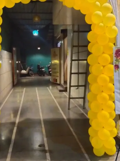 The entrance to a Haldi ceremony, marked by a bright yellow balloon arch that sets a festive tone right from the start.