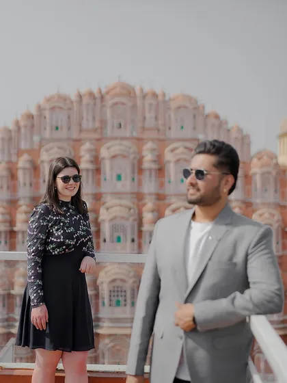 A cool, modern take on a pre-wedding shoot at Hawa Mahal, with the couple wearing sunglasses and posing with a relaxed attitude.