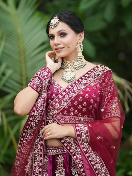 The bride posing gracefully, showing off the full detail of her outfit and jewellery.