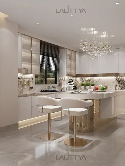 A modern luxury kitchen design blending elegance with functionality. This chic kitchen features clean white cabinets, a gold-accented island with seating, marble countertops, and a statement chandelier.