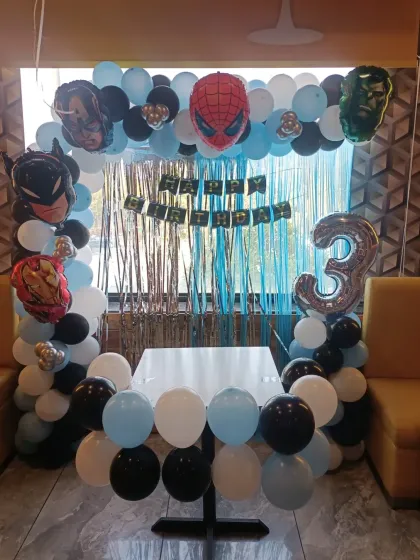 A simpler, budget-friendly Avengers setup, perfect for a smaller space or home party. This half-arch frames a dining table.