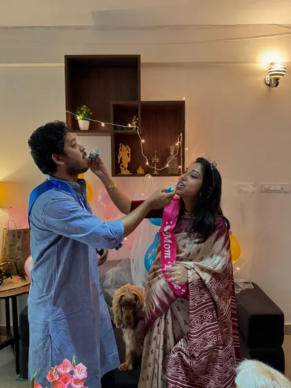 A sweet moment with my husband during the baby shower, with Posto photobombing in the background.