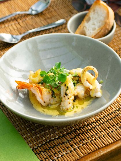 A beautiful seafood dish prepared for one of our pop-up events, featuring tender prawns and calamari in a light, flavorful sauce.