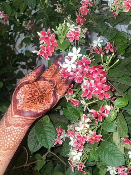 A different view of my Pakistani-style henna design next to these beautiful flowers. The intricate mandala on the palm has stained beautifully.