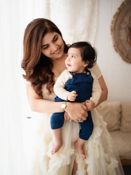 A sweet portrait of a mother looking lovingly at her baby boy.