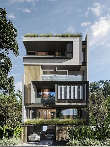 This contemporary facade features sleek louvers and WPC profiles that define the exterior. The design is complemented by strategic greenery, creating a modern aesthetic that seamlessly blends nature and innovation.