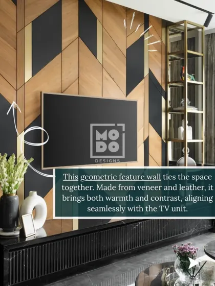 This geometric feature wall, made from veneer and leather, ties the space together. It brings warmth and contrast, aligning seamlessly with the sleek black TV unit below.