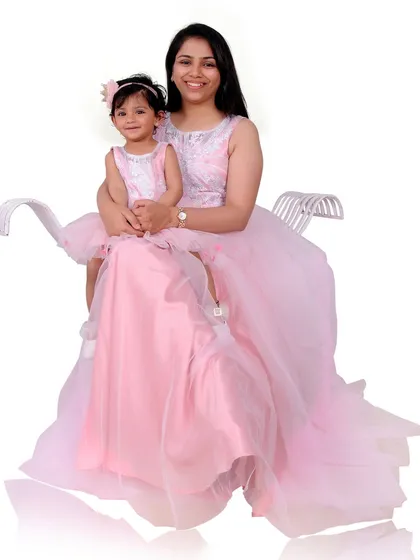 A special mother-daughter portrait session featuring matching pink gowns. I offer coordinated outfits to create a unique and adorable memory for you and your child.