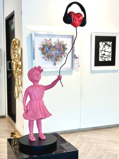 "The Rhythm of Innocence" captures a child's pure connection to music. A pink figure holds a heart-shaped balloon wearing headphones, symbolizing the immersive and joyful experience of sound.