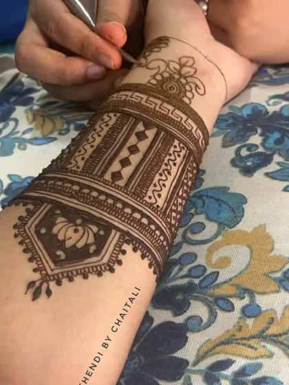 A close up of me drawing a traditional armband design. Precision and a steady hand are essential for creating these clean, intricate patterns.