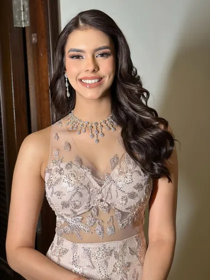 For Kavya's reception in Lonavala, I styled her hair in these beautiful, soft waves. This open hairstyle was the perfect complement to her elegant, sheer gown and sparkling jewelry.