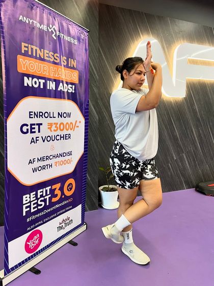 This participant holds a strong and balanced Eagle Pose, a great example of the progress our members make.