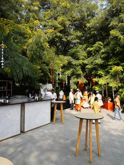 A stylish outdoor bar setup amidst lush greenery for the Haldi event.