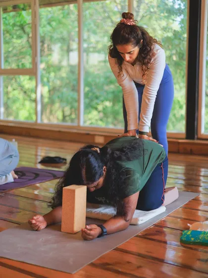 Using a block and hands-on guidance to help a student find more space and stability in this shoulder-opening posture.