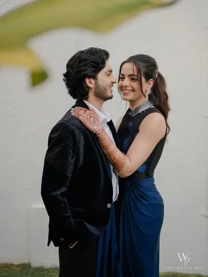 A sweet moment between the couple. Her cocktail look features a bold ombré liner, but her skin is kept fresh and glowing, letting her happiness shine.