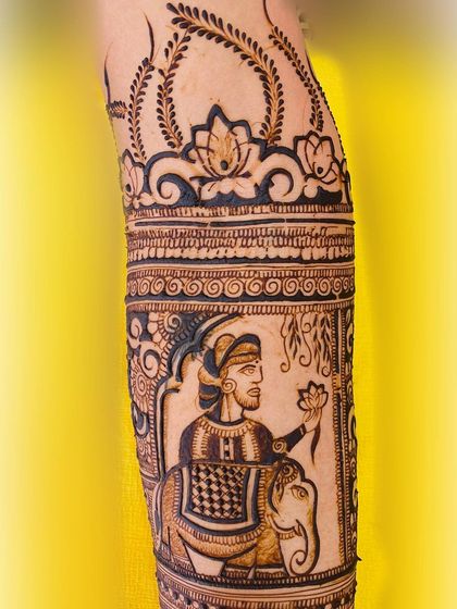 A close-up of a groom's portrait from a Rajasthani-themed bridal design. The artwork shows him seated on an elephant, holding a lotus, capturing the regal and romantic essence of the theme.