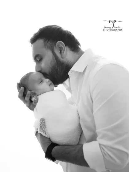 The strength and tenderness of a father's love, captured in a classic black and white portrait. These simple, powerful images focus on the deep connection and emotion of welcoming a new life.