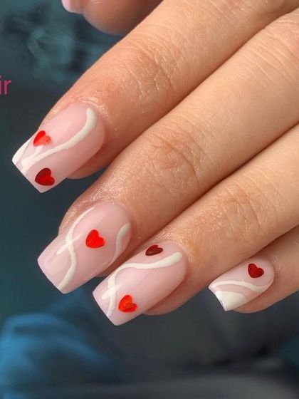 A romantic design with red hearts and white swirls on a sheer pink base.