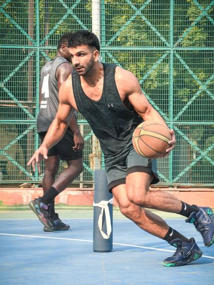 A player driving hard during a group workout. The competitive energy helps everyone elevate their game.