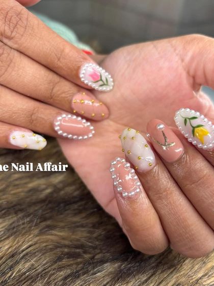 A truly unique and detailed set, these nails feature hand-painted tulips framed with tiny pearls, along with other delicate 3D accents.