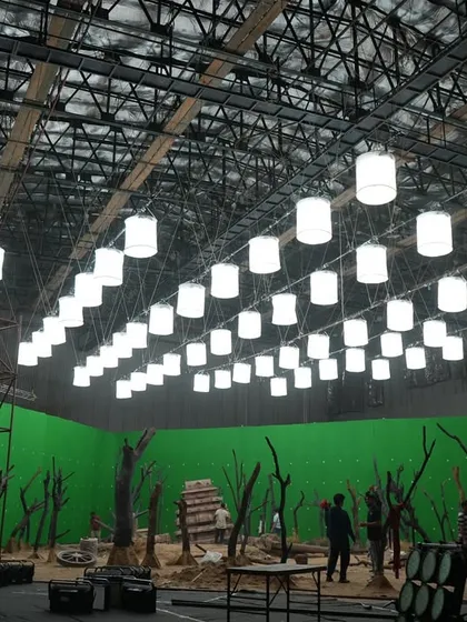 A massive green screen set for a Coca-Cola commercial, lit by a ceiling grid of over 80 Prolight ECL panels arranged as hanging lanterns.