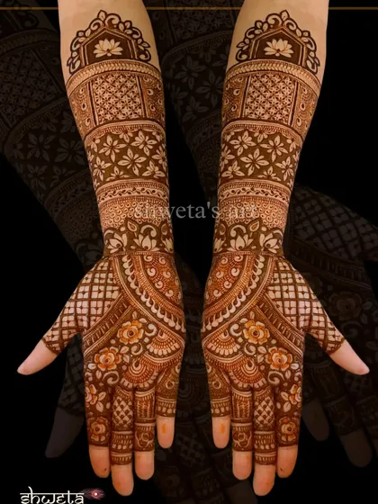 A classic Indian mehendi design with a mix of floral bands, lotus motifs, and jaali patterns. This is a timeless choice for a bride or for any festive celebration.