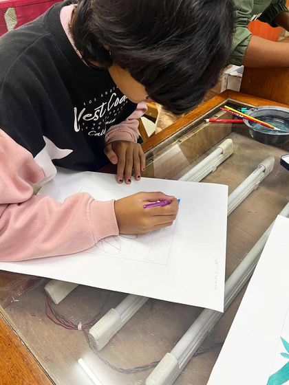 Students at our silkscreen workshop focused on preparing their designs by blocking out colors on paper.