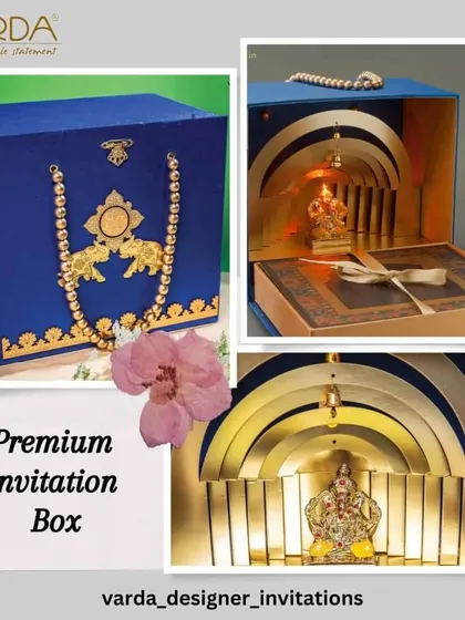 A premium invitation box in royal blue velvet, featuring a stunning 3D Ganesha idol revealed within golden arches. This design is the epitome of luxury and devotional artistry.