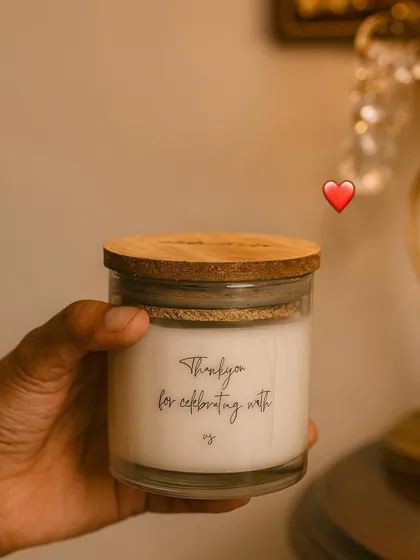 A candle perfect for all occasions. This simple glass jar candle with a wooden lid says 'Thank you for celebrating with us,' a small token of love for the people who matter.
