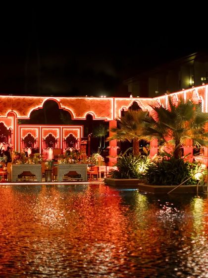 The 'Midnight Marrakesh' setup reflecting in the central pool of the venue. The illuminated structures created a magical, soulful ambiance for the evening.