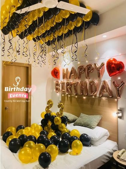 Another popular bedroom setup, this time with black and yellow balloons covering the bed and ceiling for a 23rd birthday.