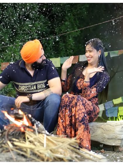 A cozy bonfire scene for a pre-wedding shoot. This setup is perfect for creating a warm, intimate, and romantic atmosphere, especially with the playful snow effect.