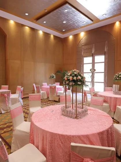 The indoor seating arrangement for a day function, with pink and white themed decor creating a soft, romantic ambiance.