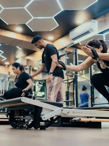 Here you can see me providing an adjustment during a group class. Even in a group setting, I ensure each client is using the correct form to get the most out of every movement.