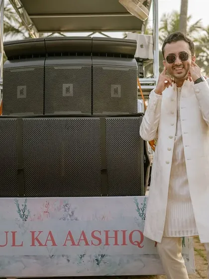 The groom, Aashay, is surprised by the volume of the speakers at his own baraat. His playful reaction is a perfect example of the funny, unscripted moments that happen during wedding processions.
