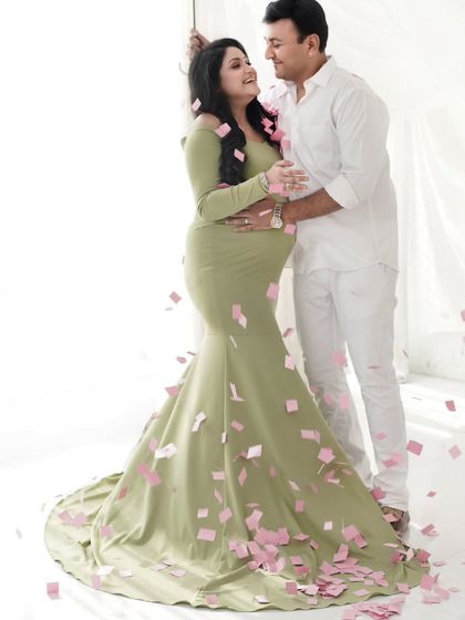 A moment of pure joy and celebration. We used confetti to add a playful and happy element to this couple's maternity shoot.
