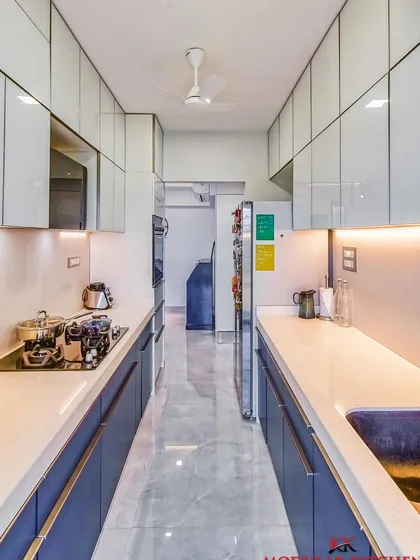 A parallel kitchen design with a super matt laminate finish and back-painted glass accents, creating a sophisticated and practical space.