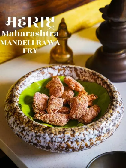 Crispy Mandeli Rawa Fry, a Maharashtrian seafood delicacy, served in a rustic stoneware bowl. The simple presentation on a banana leaf highlights the crunchy texture of the dish.