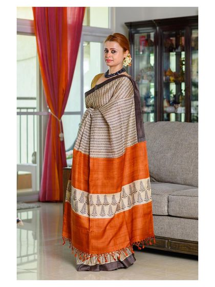 Another shot from the same series, this time with the model standing, giving a full view of the striped and block-printed saree.